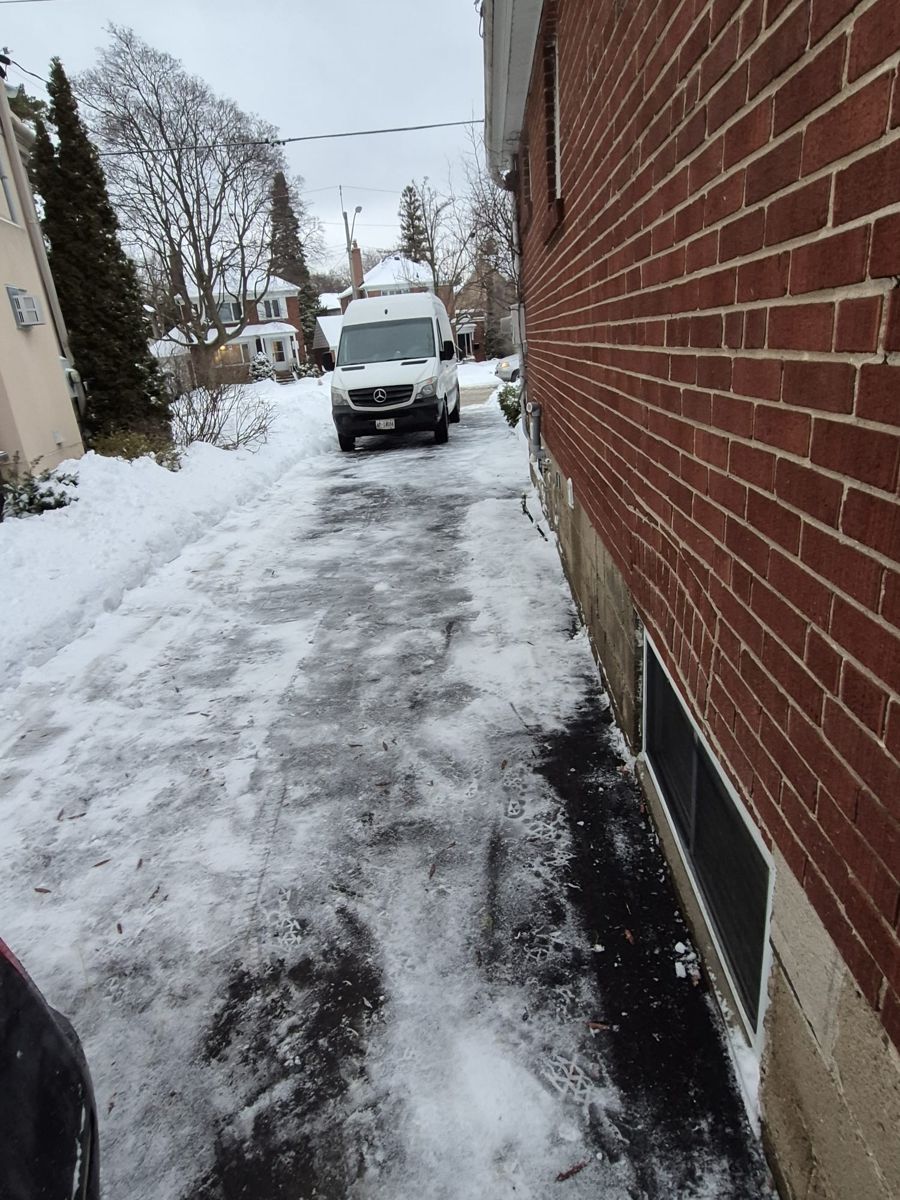 Driveway next to a brick home after snow and ice were removed